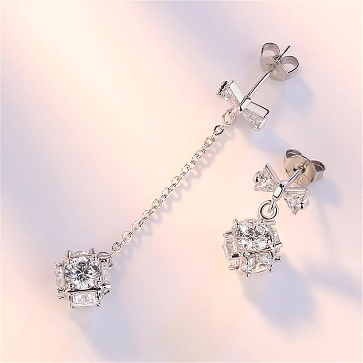 Cubic Zirconia & Silver-Plated Bow Asymmetrical Drop Earrings